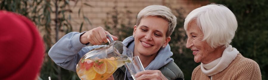 Caregiver serving drinks to an older client