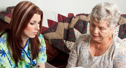 Caregiver visiting with an older client at home