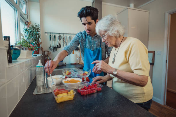 Grandson preparing food with his grandmother
