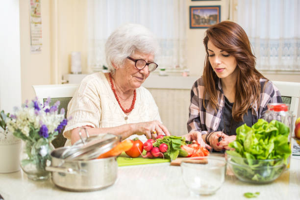 Grandmother and granddaughter preparing food together