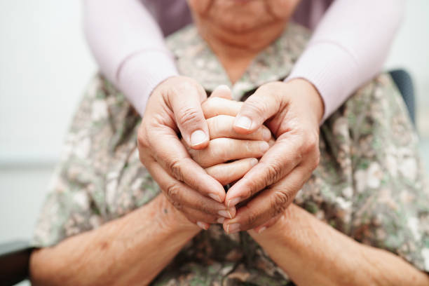 Caregiver holding an older client's hands