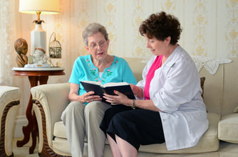 Caregiver reading with an older client